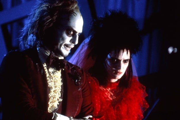 Michael Keaton and Winona Ryder standing side-by-side in a scene from &quot;Beetlejuice&quot;