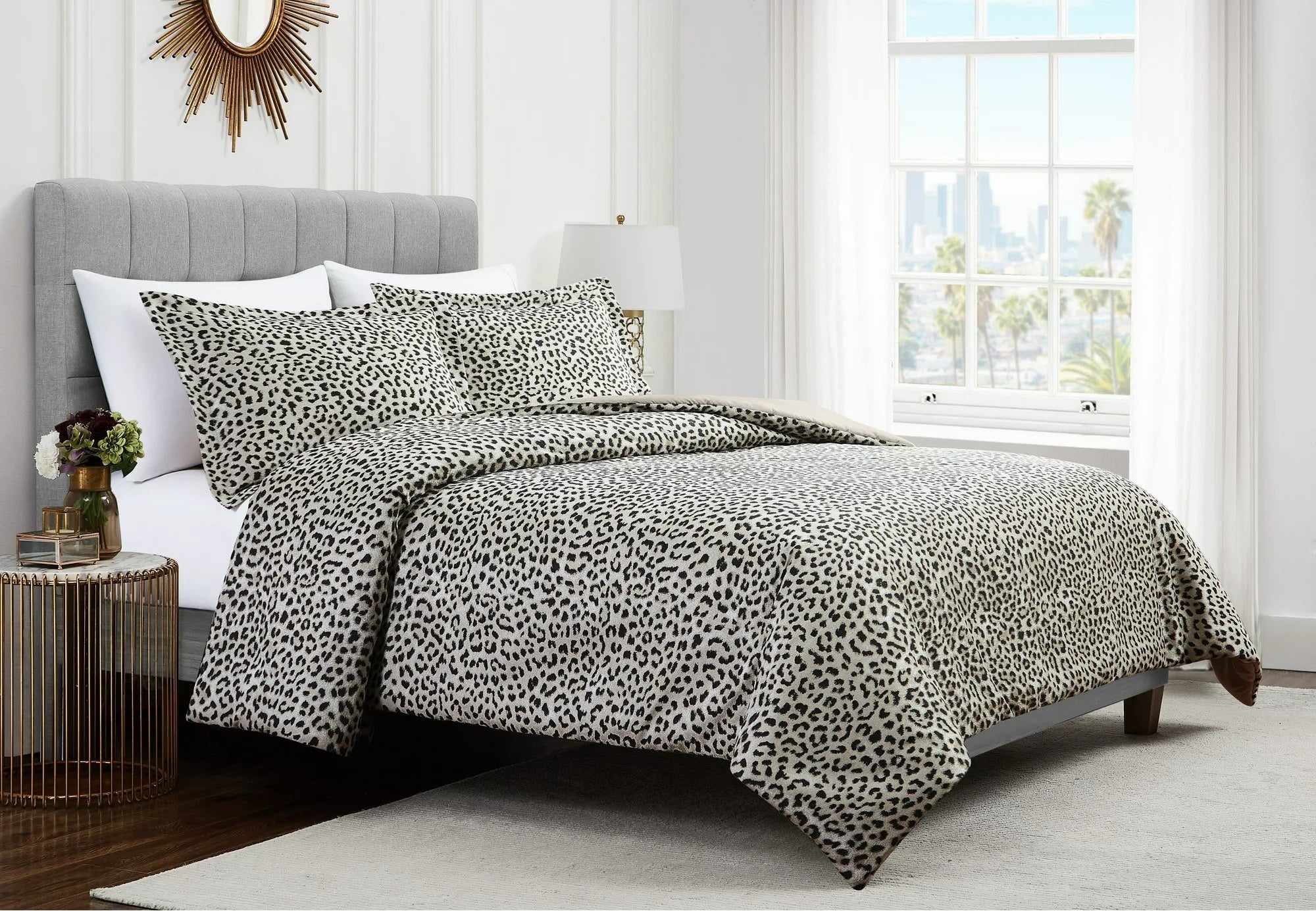 Leopard comforter set with matching shams on bed