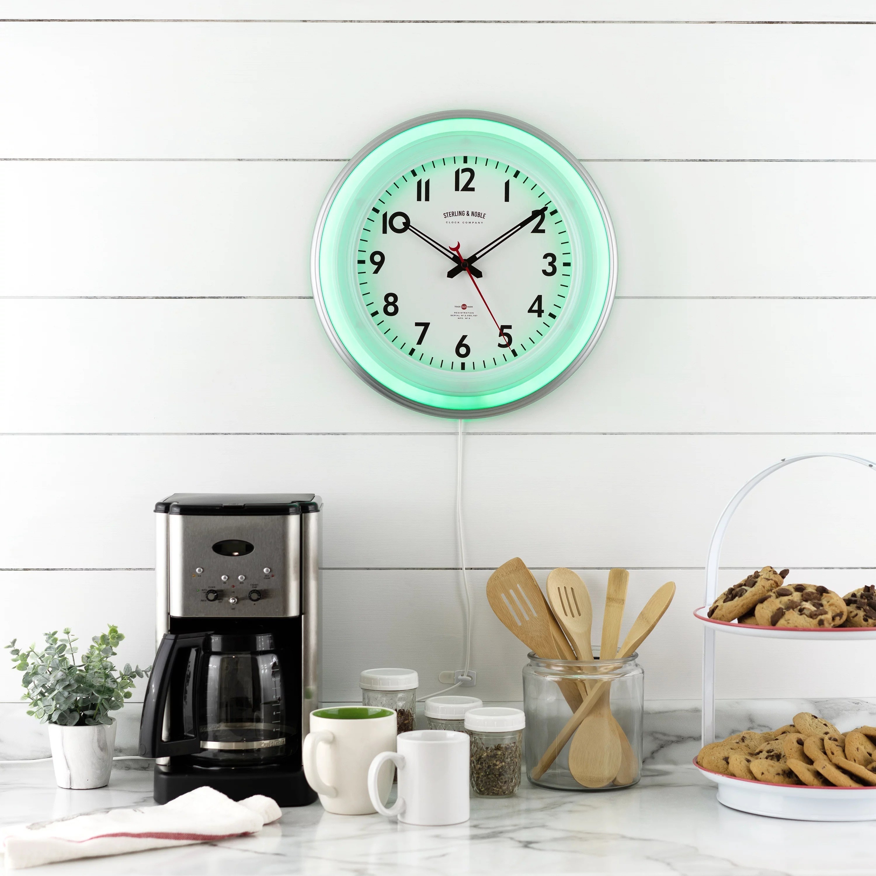LED wall clock on kitchen wall, with green light on