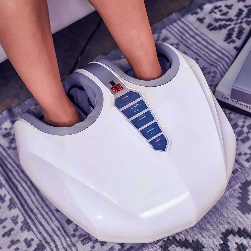 Image of someone using white foot massager