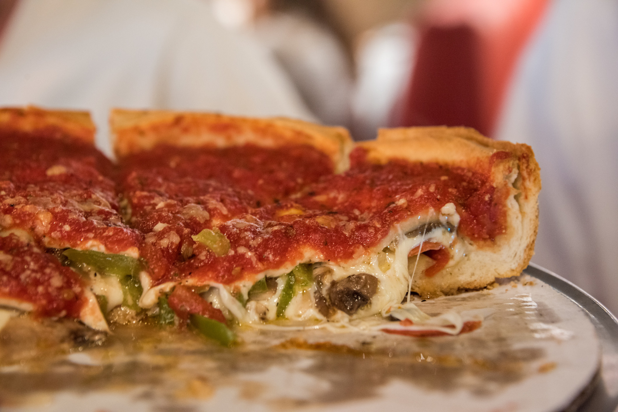 Close up of a sliced Chicago-style deep dish pizza.