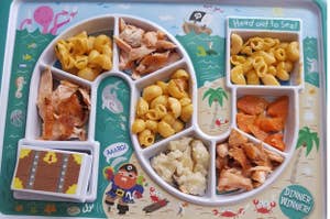 a nautical-themed dinner tray with eight compartments for holding kids food portions