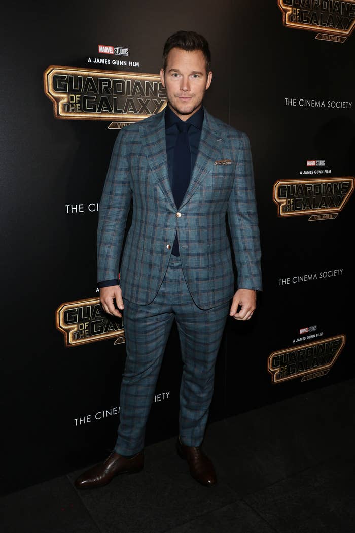 Chris Pratt wears a plaid suit at a red carpet premiere