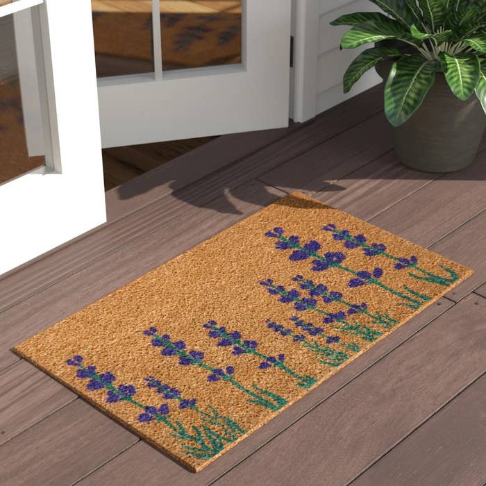 the door mat with purple and green lavender flowers on it