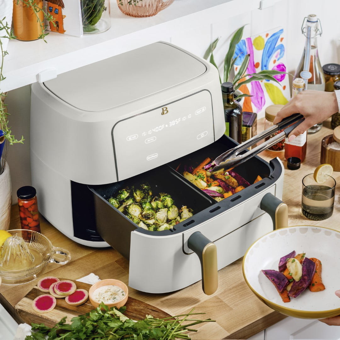 someone using the double barrel air fryer to cook veggies