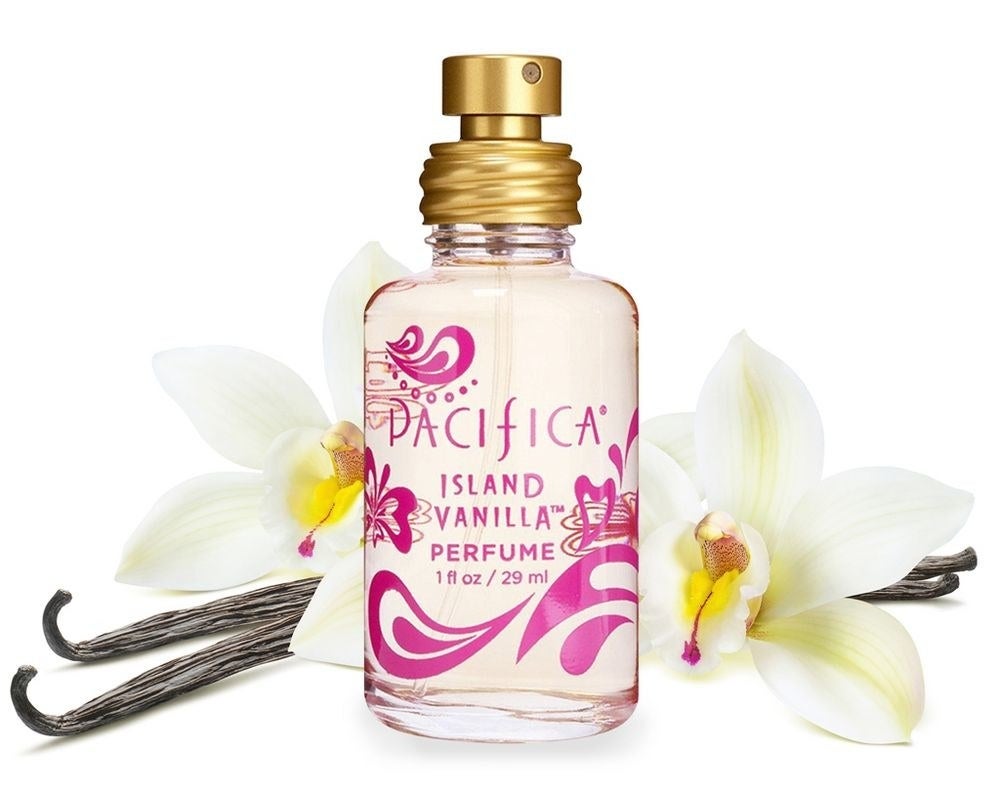 A photo of the perfume with vanilla flowers behind it