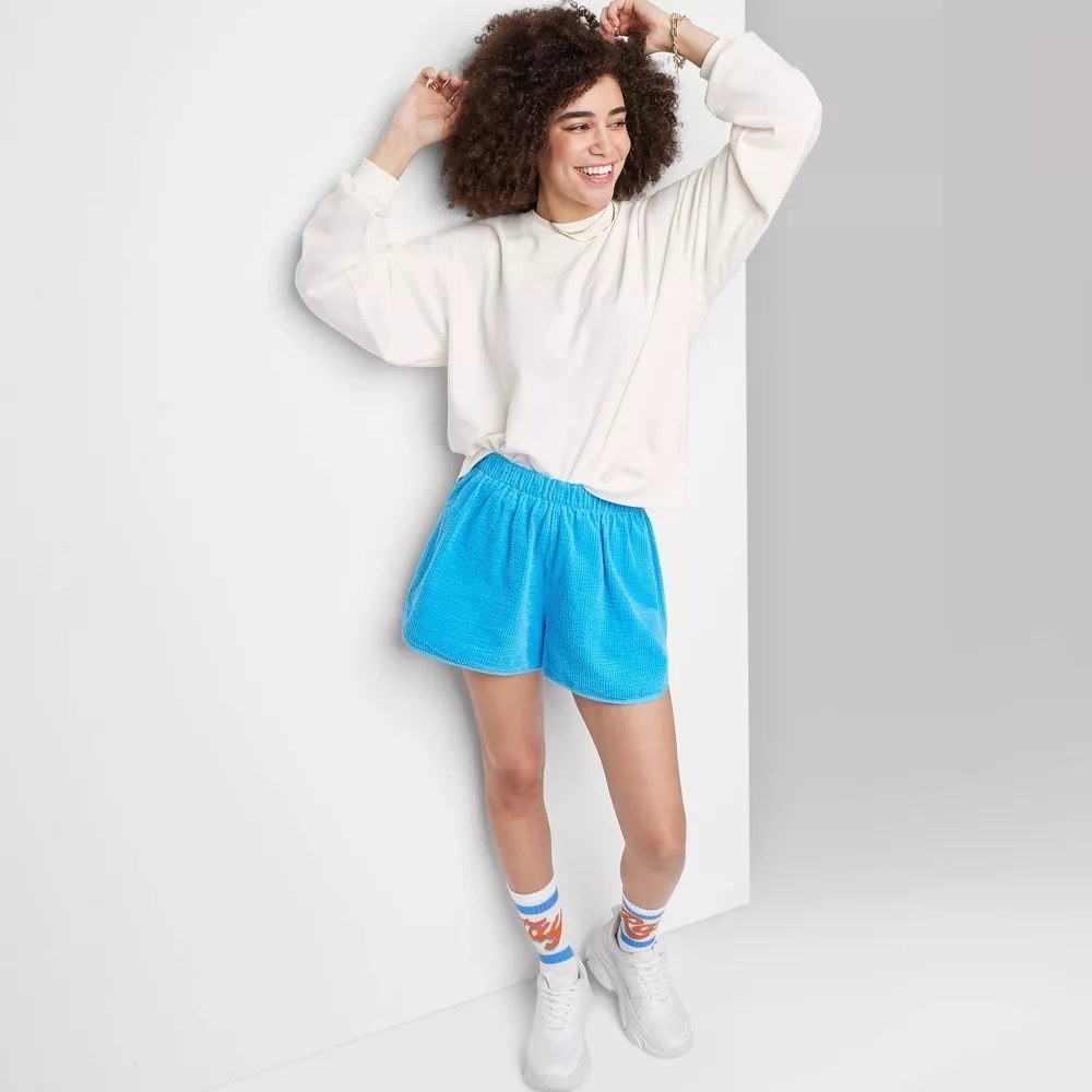 A model in the bright blue baggy shorts