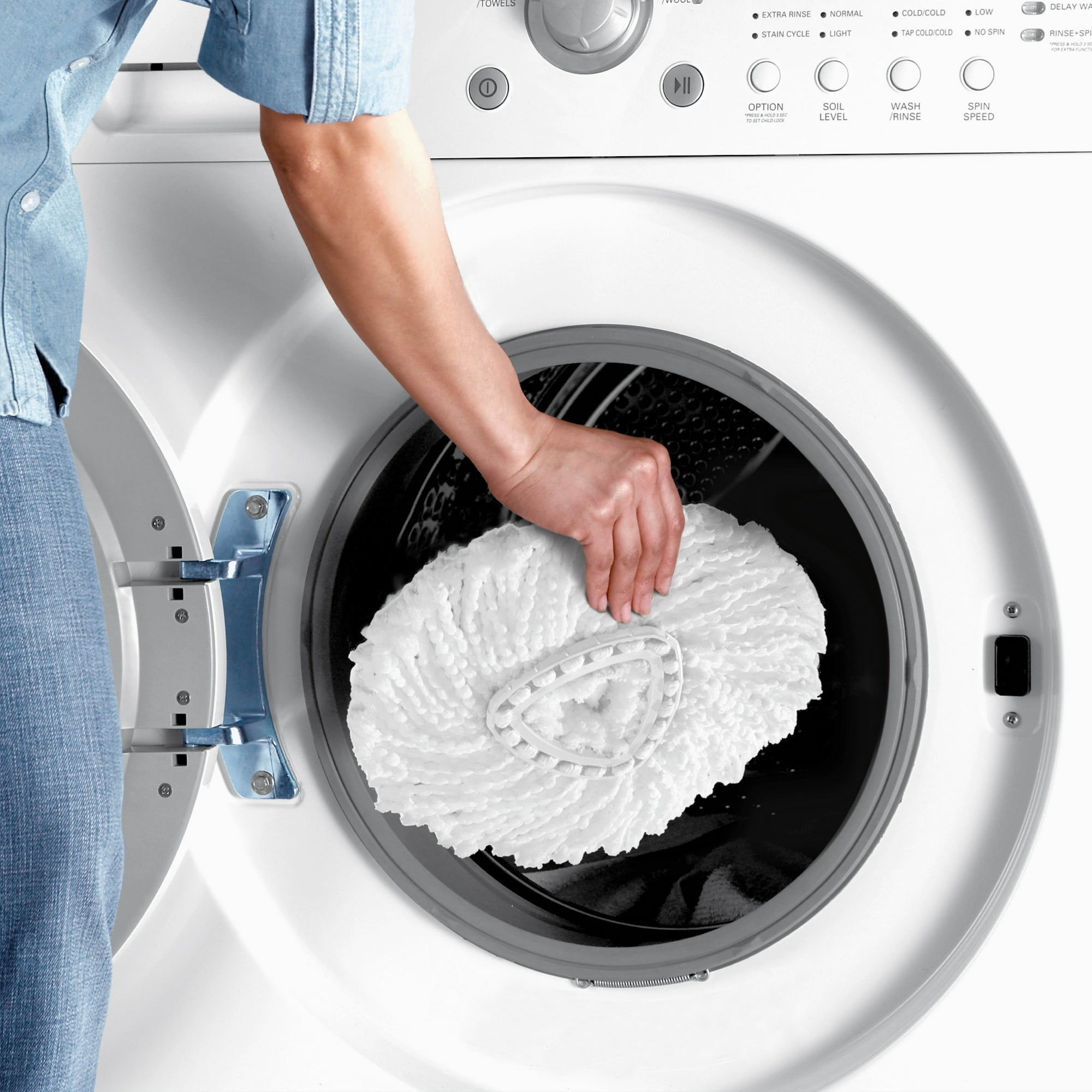 someone throwing the mop caput  into a washing machine