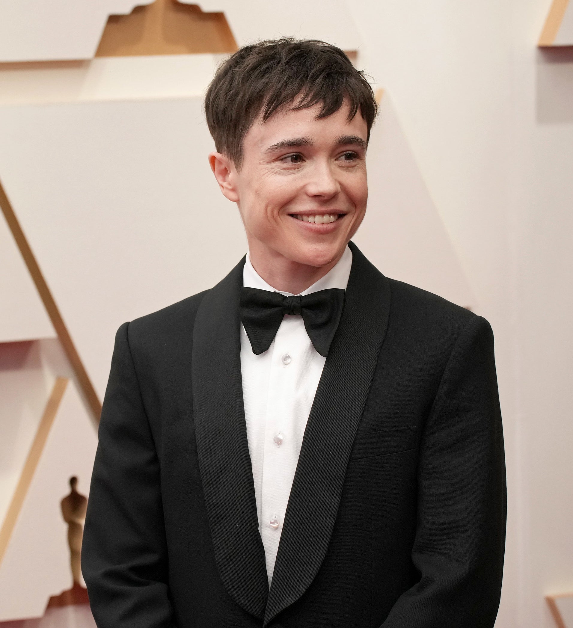 Close-up of Elliot smiling in a suit and bow tie