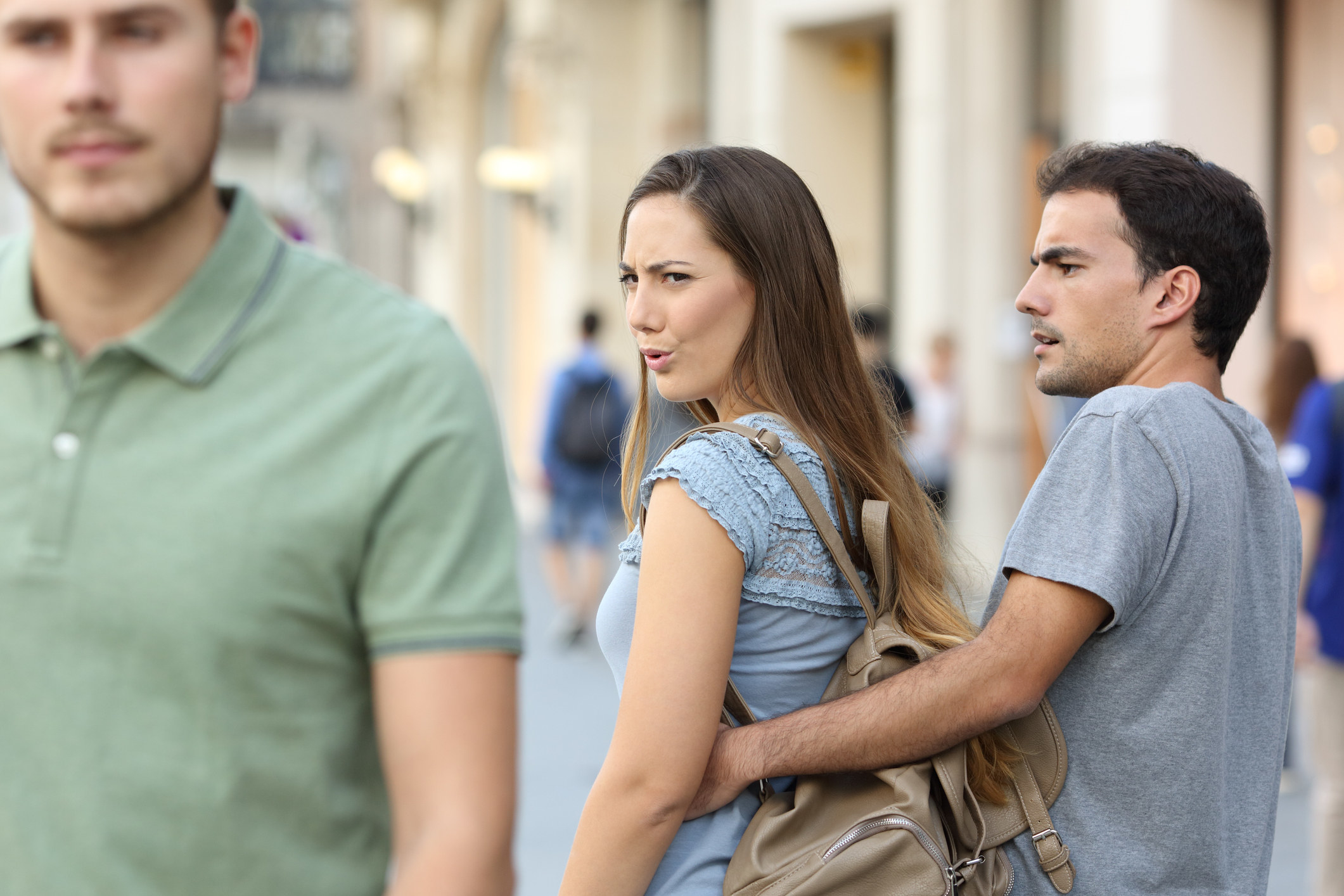 Woman with a man while looking at another man