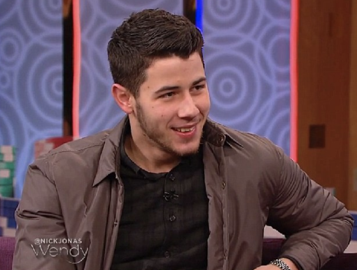Close-up of Nick smiling on the Wendy Williams Show