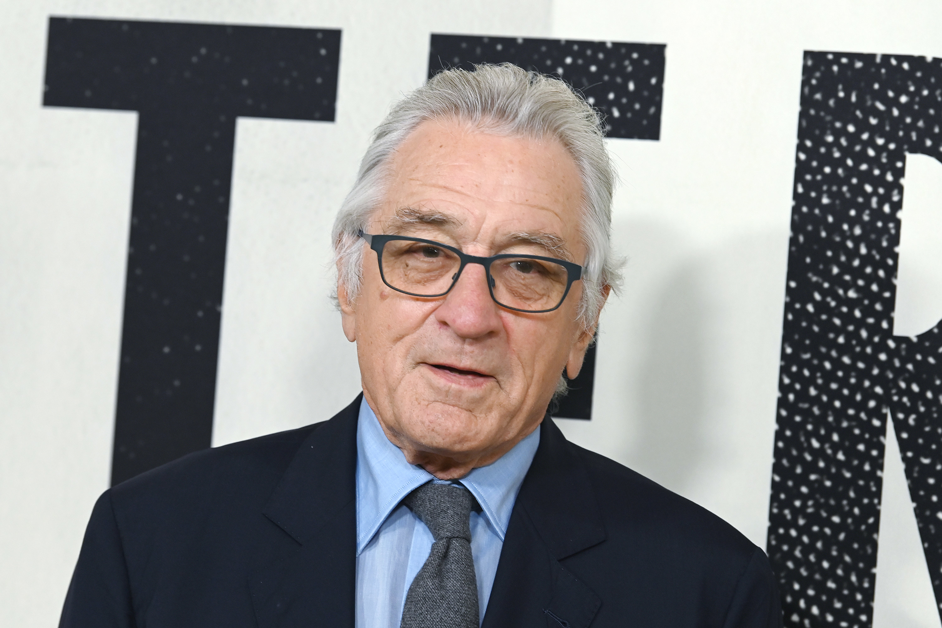 Close-up of Robert in a suit and tie at a red carpet event