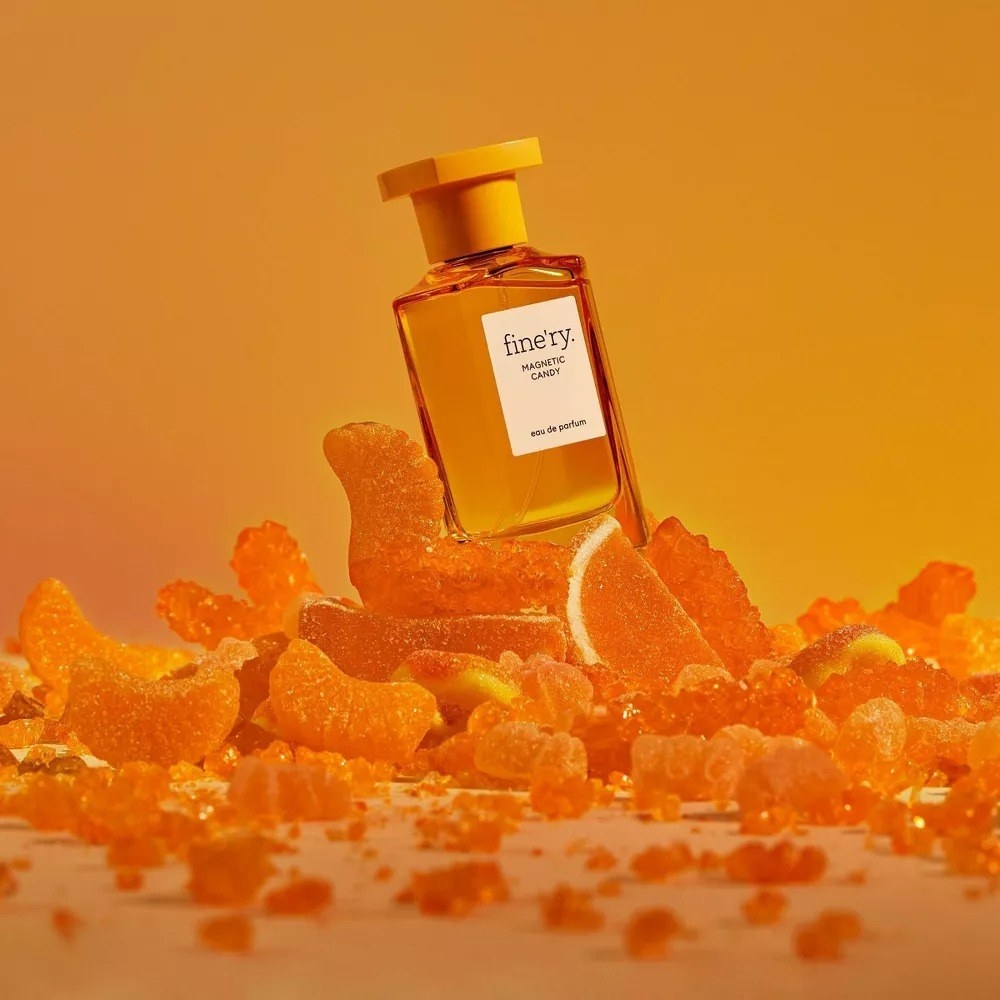 the fine&#x27;ry Magnetic Candy fragrance sitting on top of candied fruits.