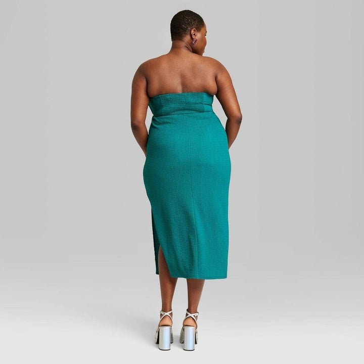 the back of the strapless dress in teal green