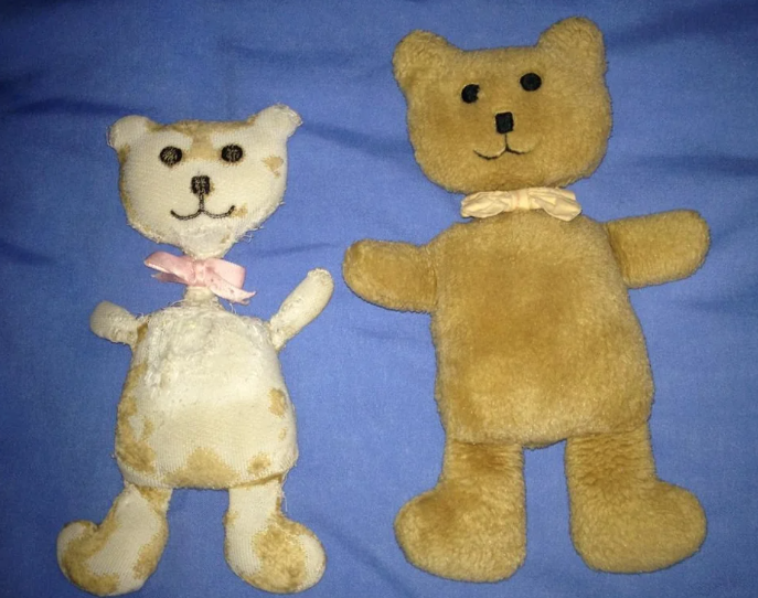 Two teddy bears on a bed