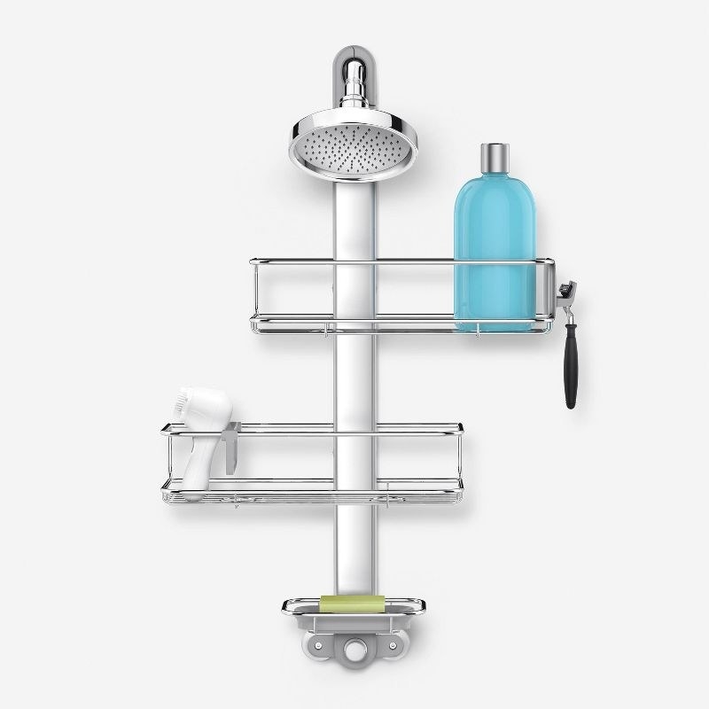 a shower caddy with three adjustable shelves holding soap, a razor, and shampoo