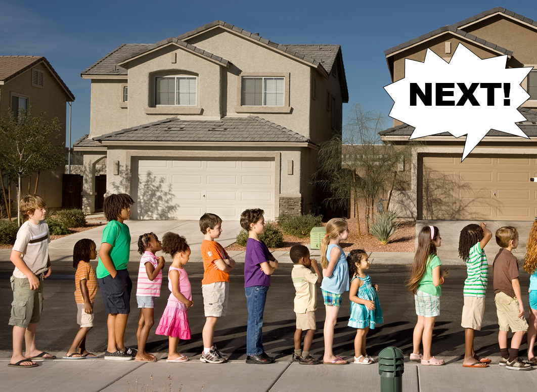 A group of kids wait in line on a suburban sidewalk