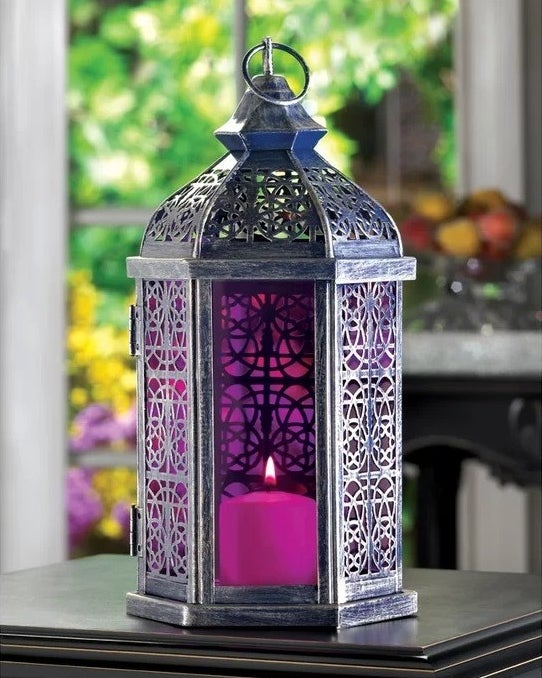 the purple and metal lantern with a candle inside