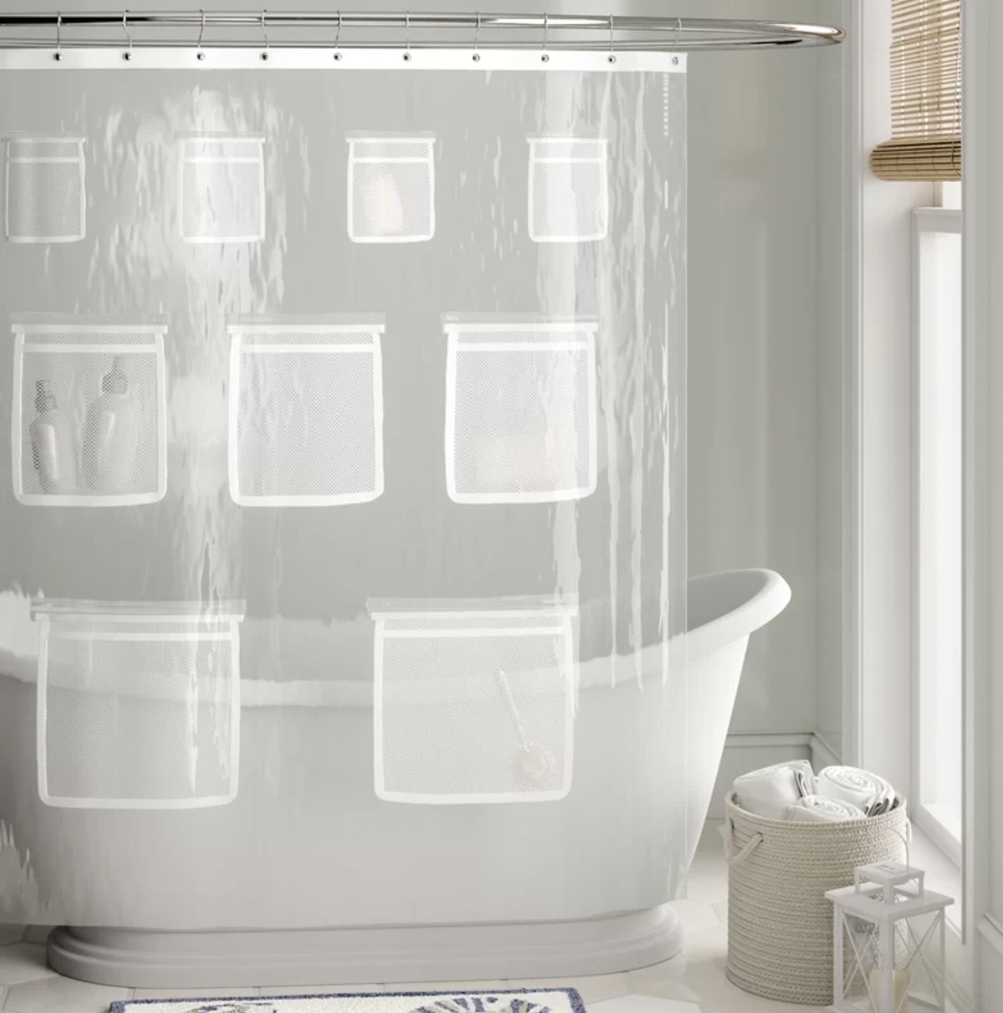 the shower curtain above tub with four small pockets, three medium pockets and two large pockets