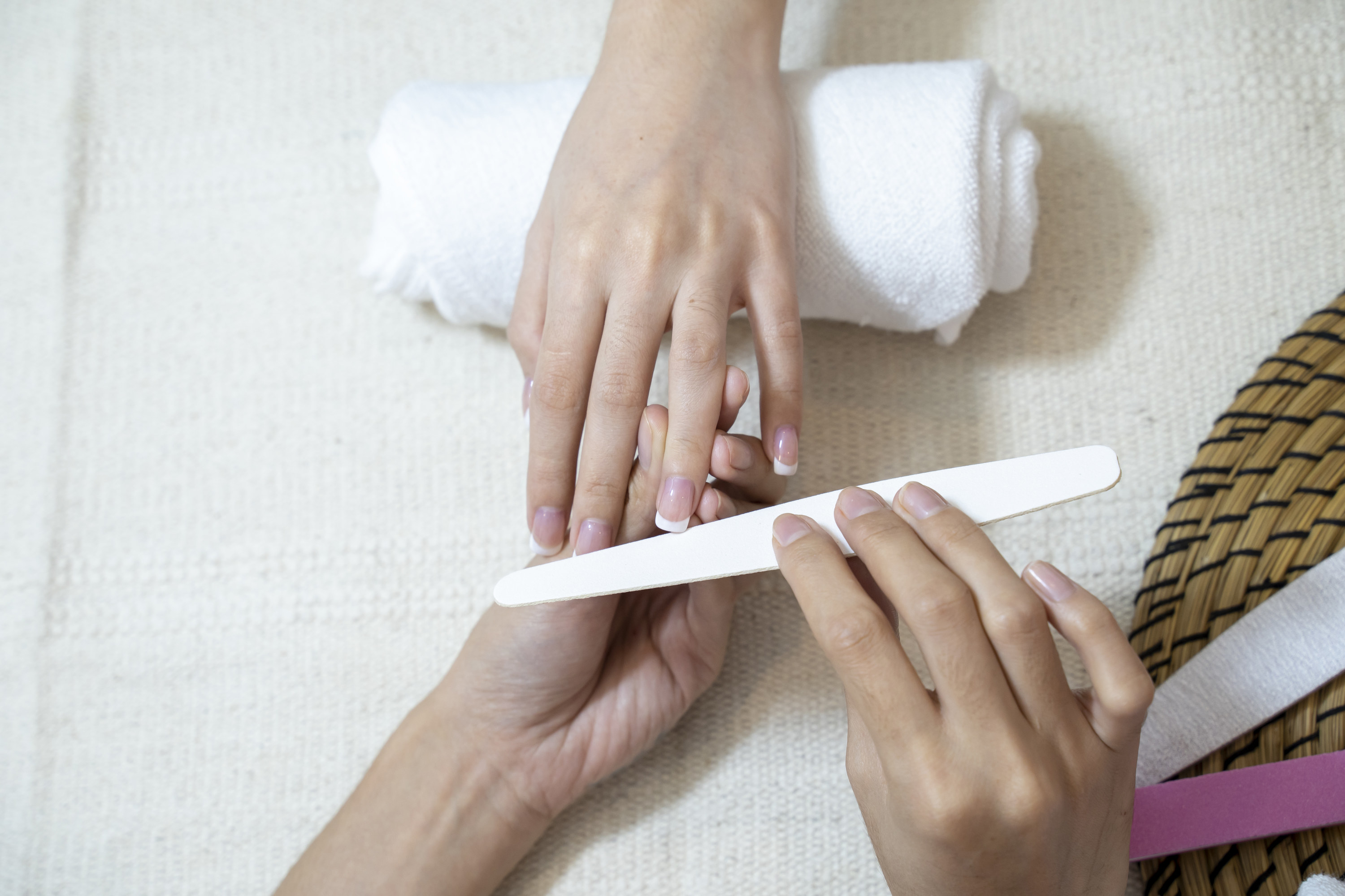 Manicurist filing nails