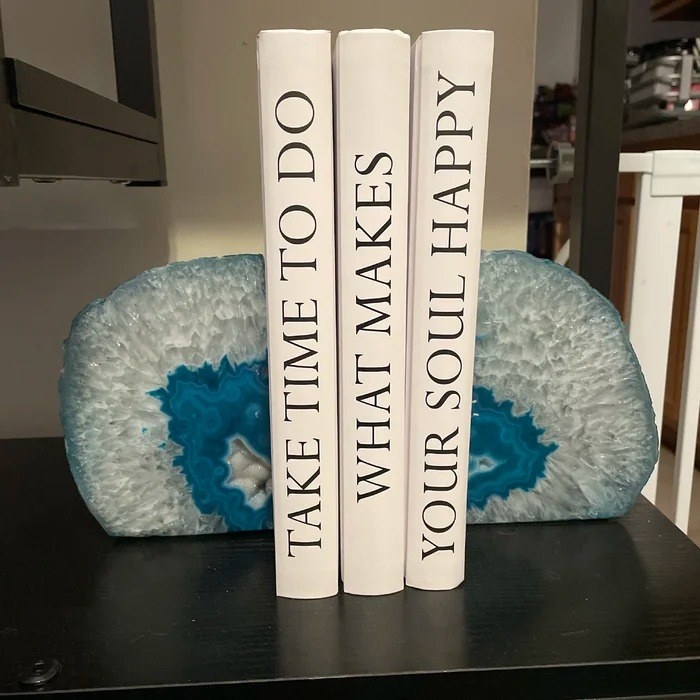 the blue bookends holding three books