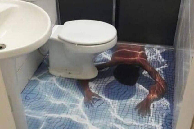 A bathroom with a vinyl overlay on the floor that has an image of a child swimming underwater on it