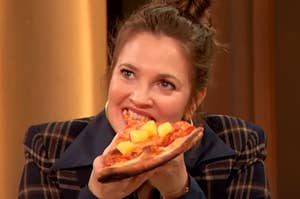 Drew Barrymore eating a piece of pizza