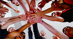 The cast of &quot;Glee&quot; having a hands in moment before a performance