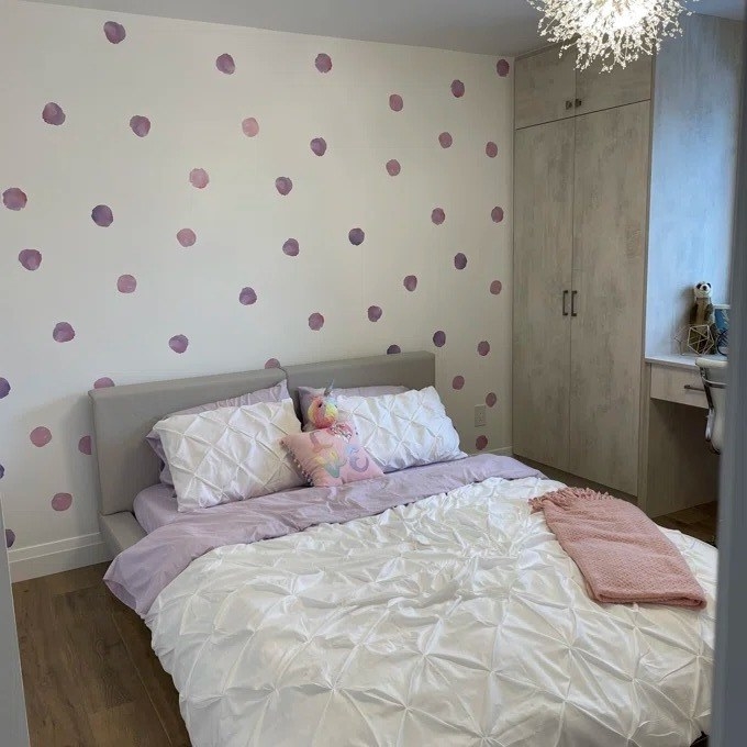 a reviewer photo of the pink dots on a white wall of a bedroom