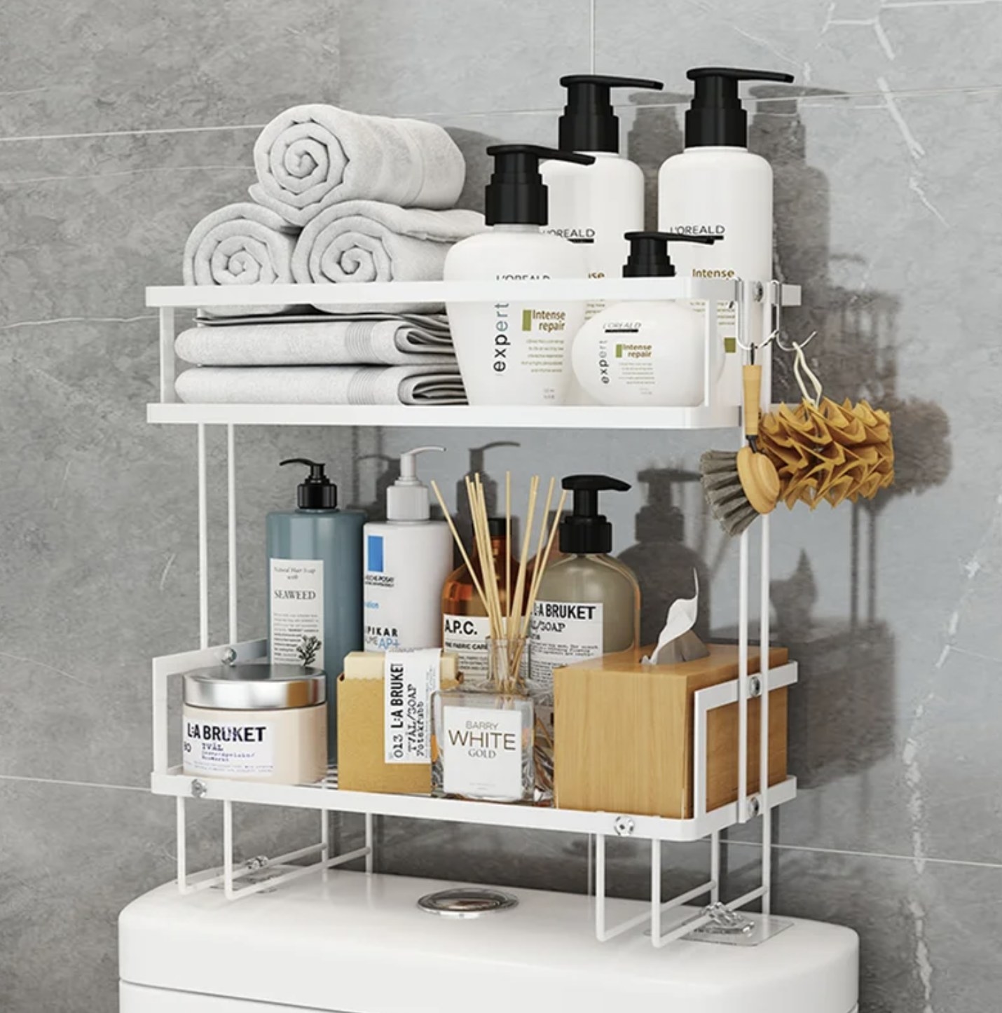 the white rack on toilet filled with soaps, washcloths, and other items