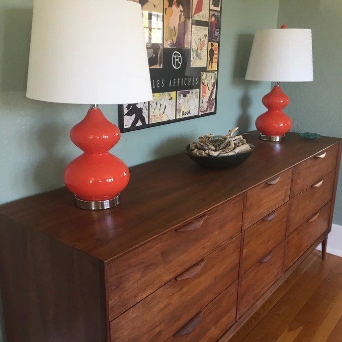a reviewer photo of the blood orange lamps on a dresser