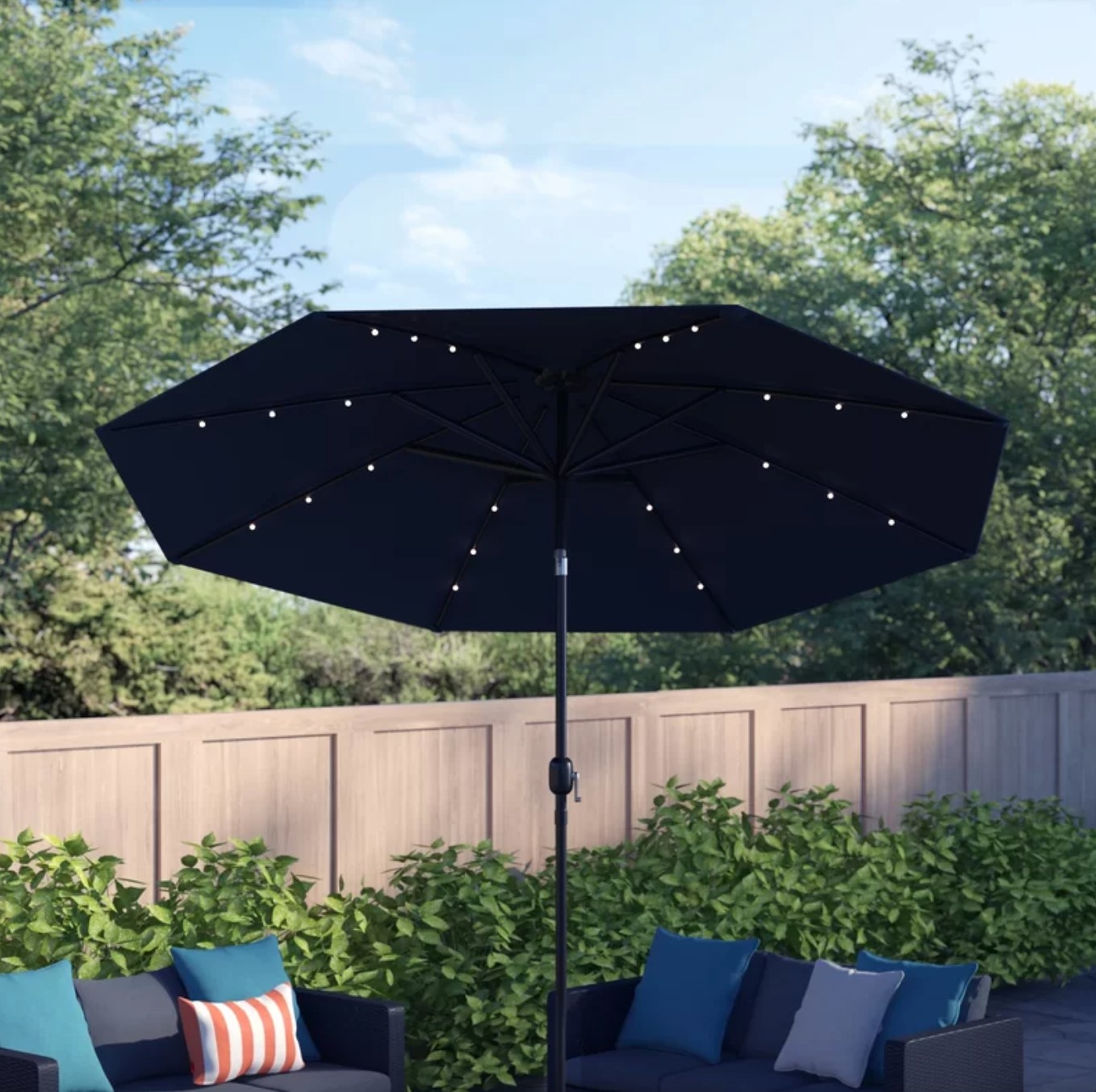the black umbrella with LEDs on the underside in a decorated outdoor space