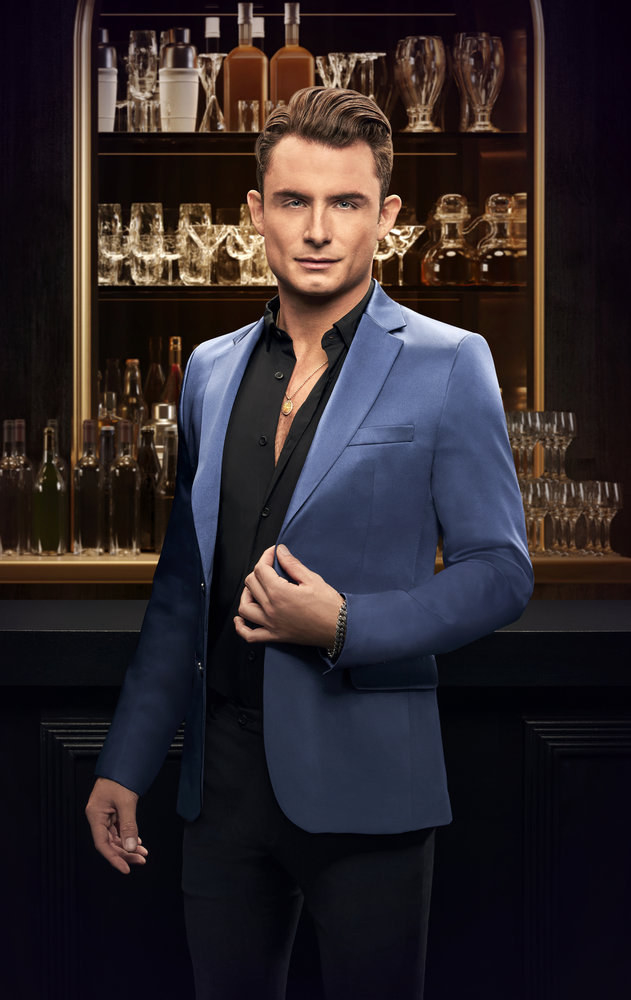 james kennedy in vanderpump rules promotional photo standing in front of a bar