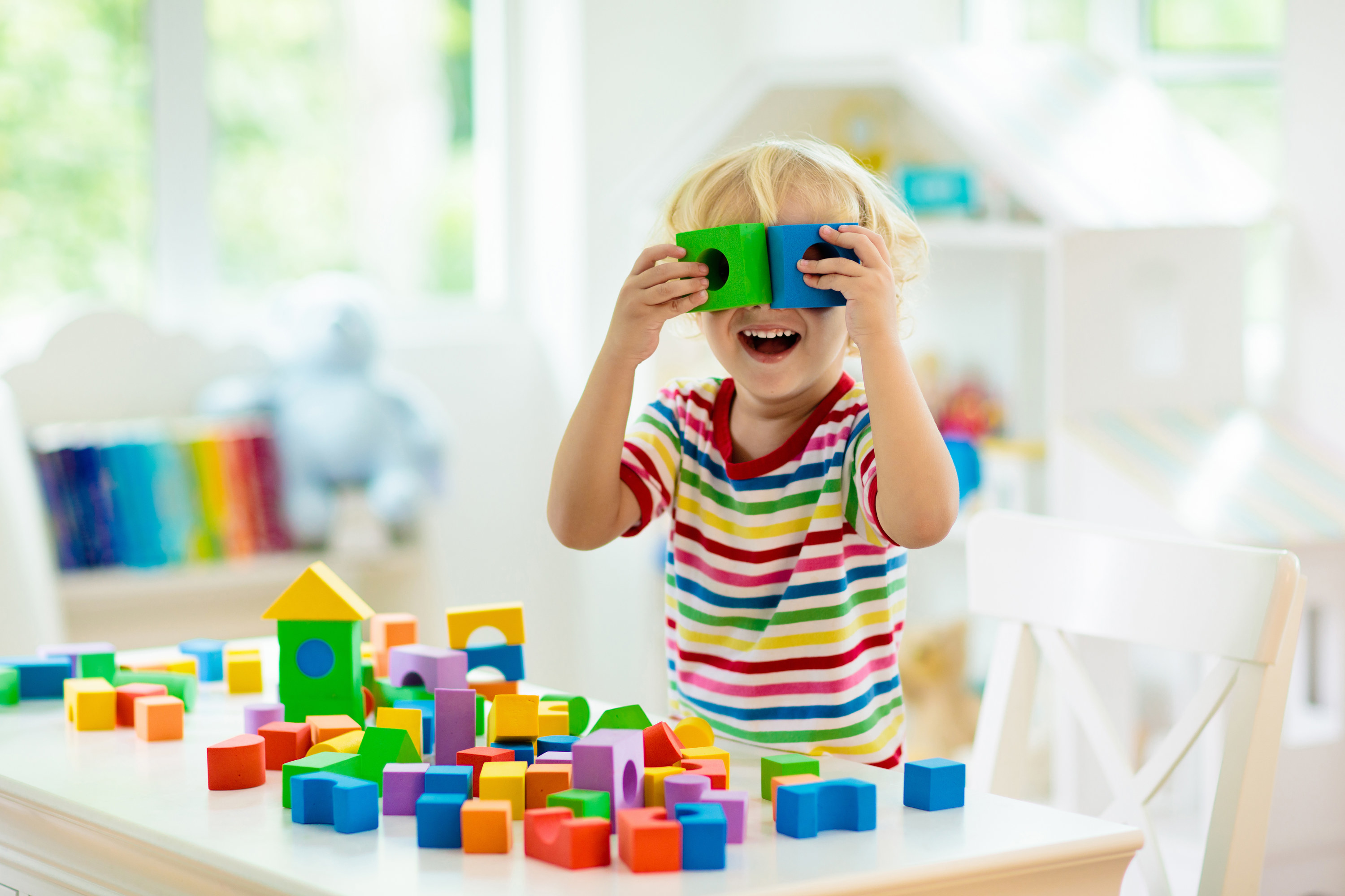 Toddler playing with colorful blocks