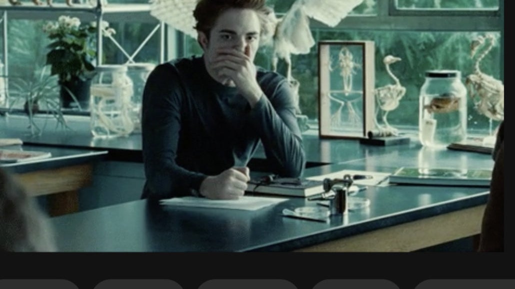 Edward sitting at a table by a window