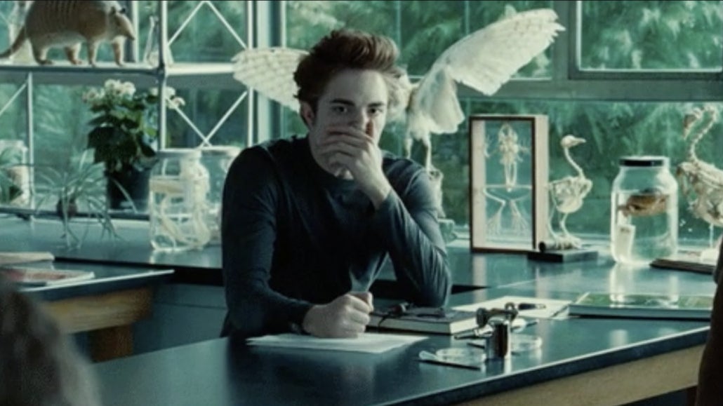 Edward sitting at a table by a window