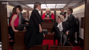 A group of people stands up into the ceiling of a small room