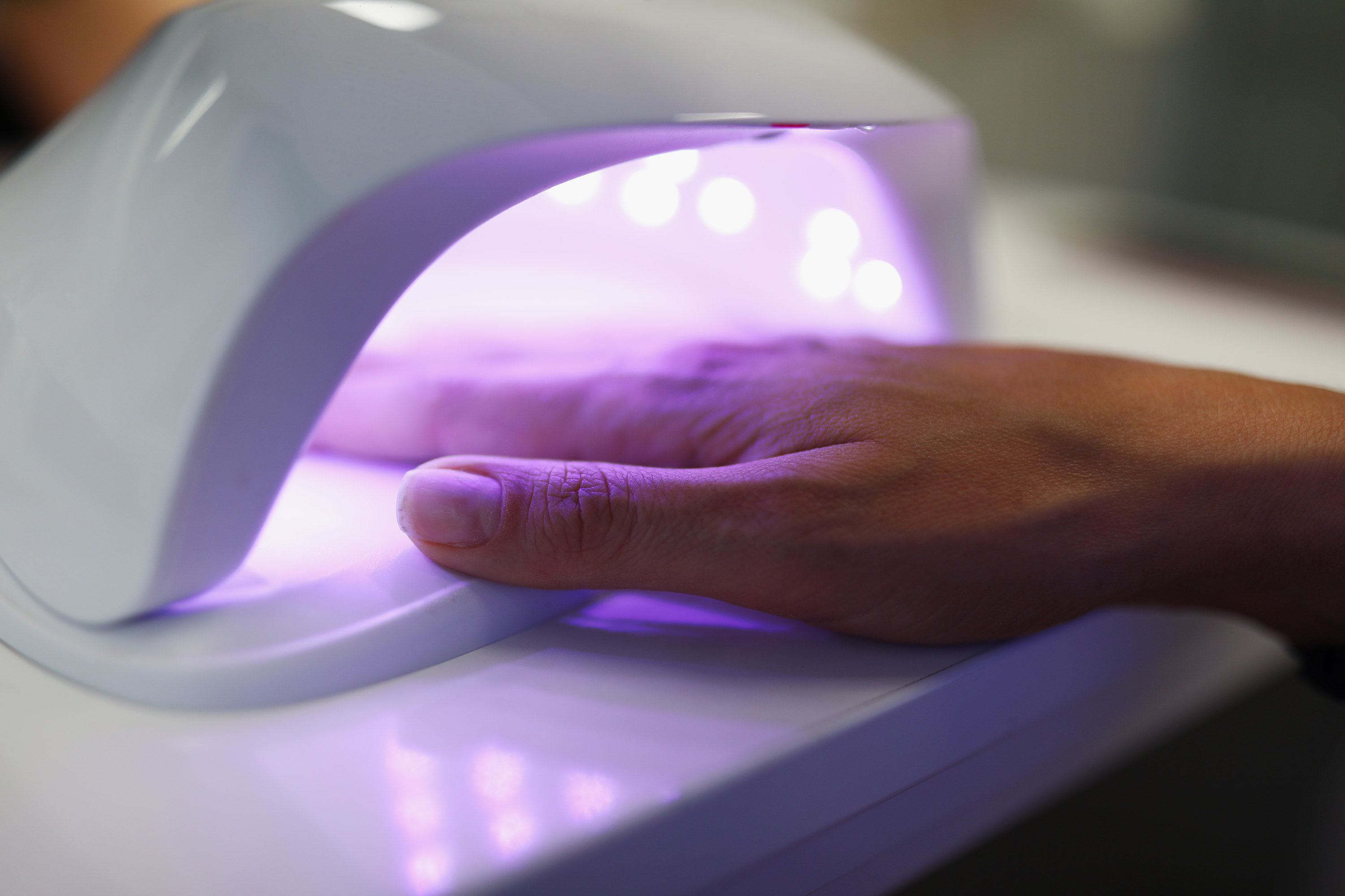 Close-up of hand under uv lamp