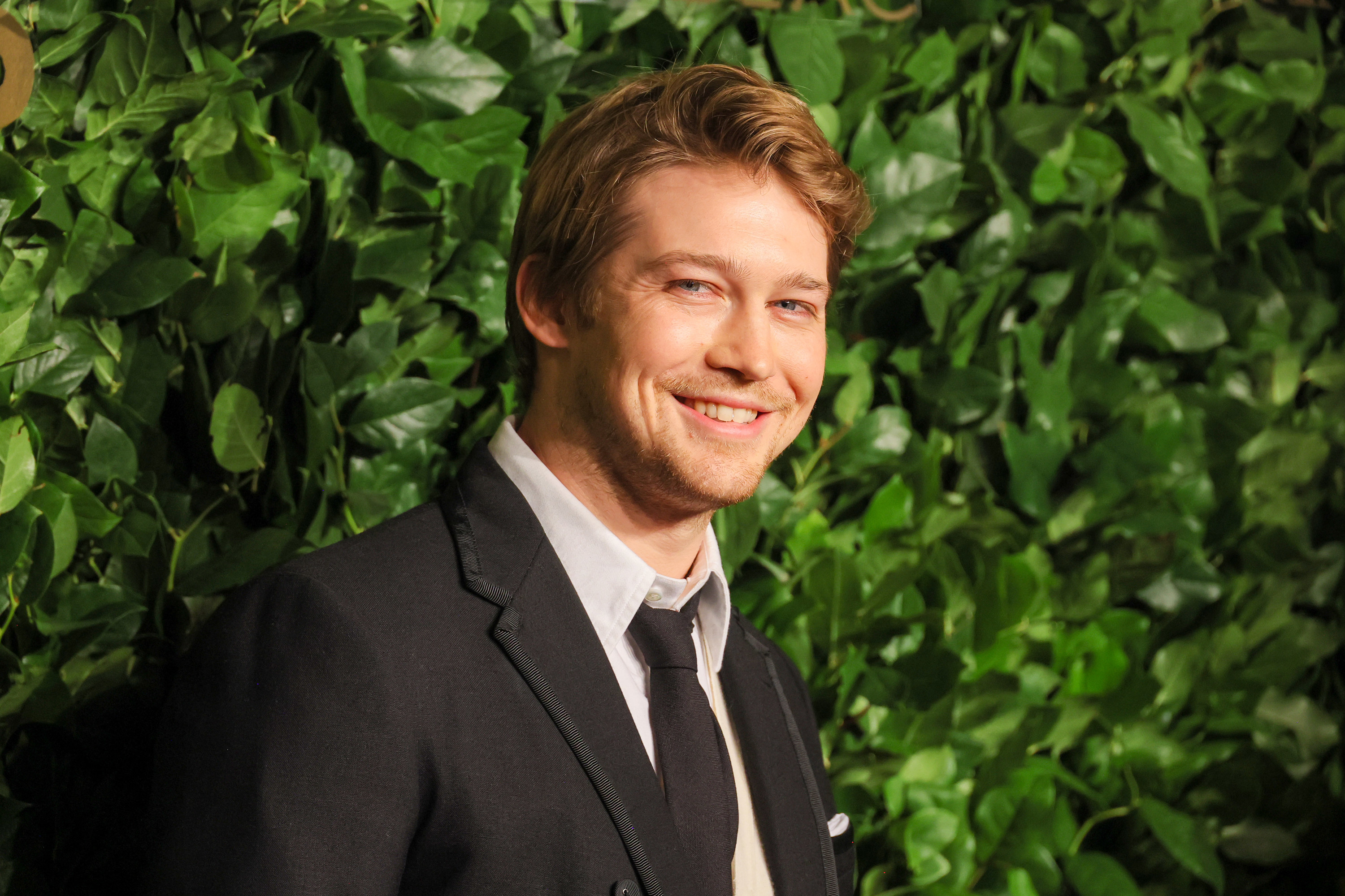 Close-up of Joe smiling in a suit and tie