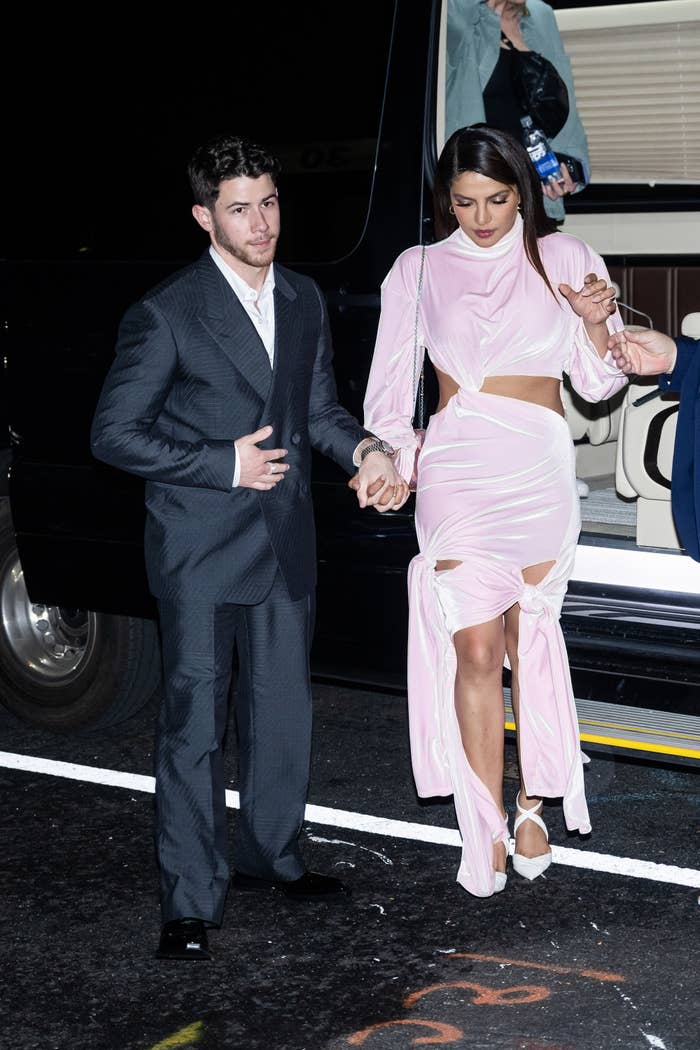 nick holding her hand as she gets out of the car