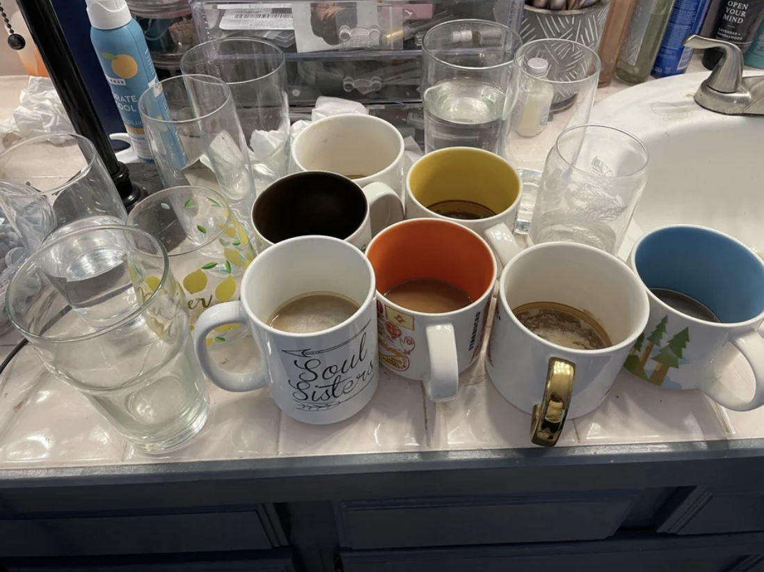 mugs and glasses cluttering the sink