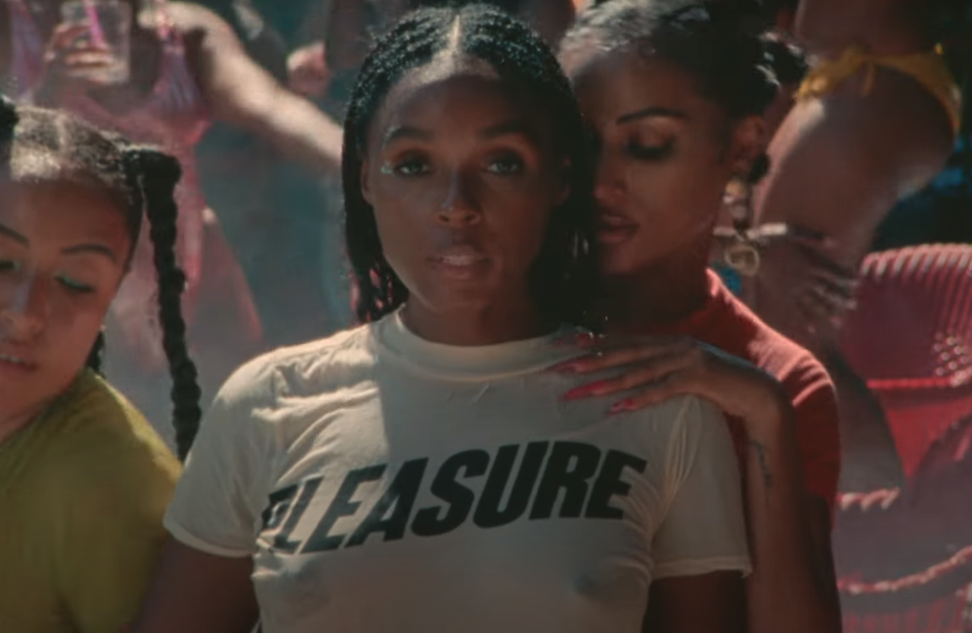 Janelle wearing a wet shirt that says Pleasure