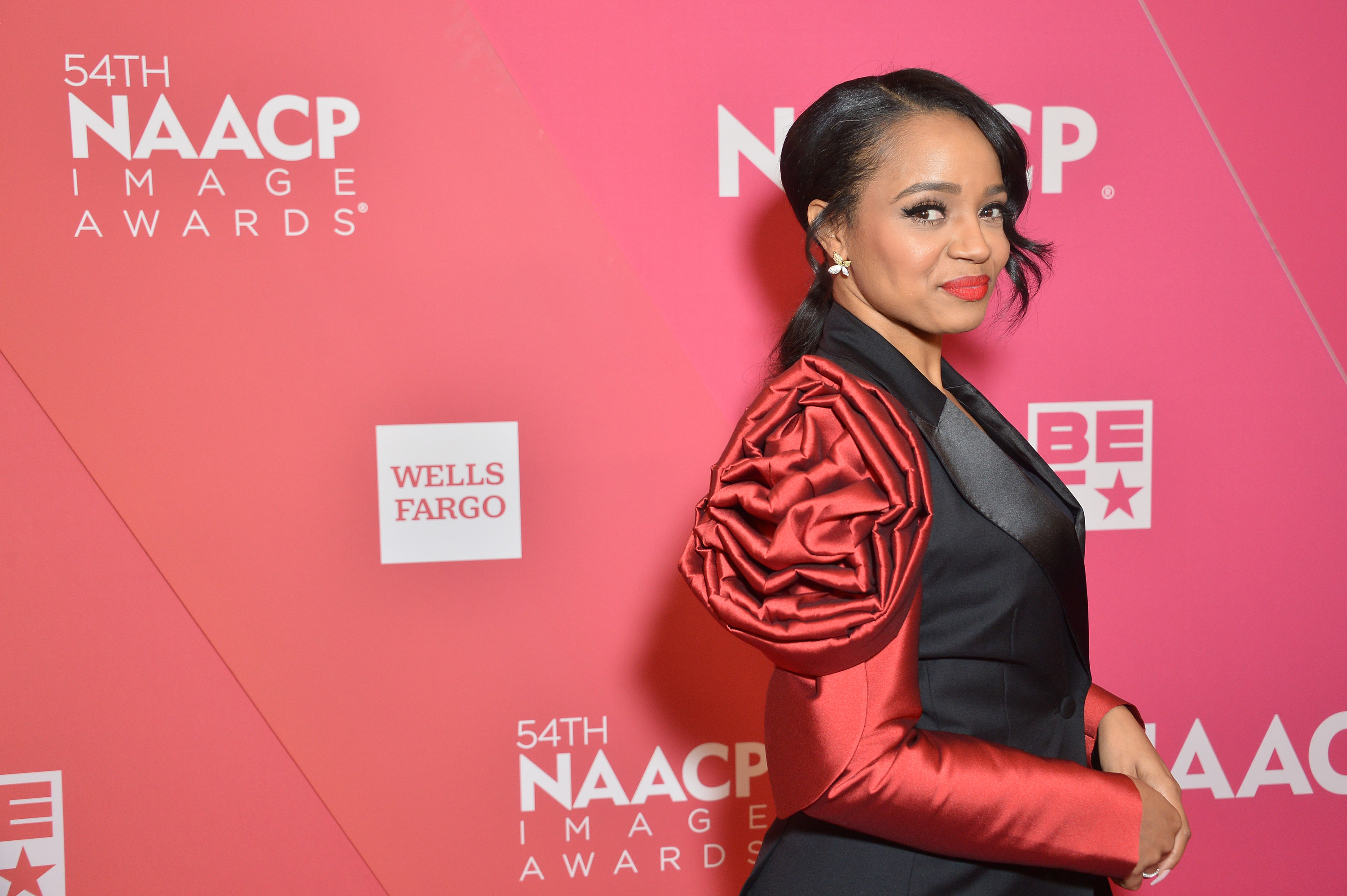 A side profile of Kyla on the 54th NAACP Image Awards. Kyla is wearing a luxe two-tone pantsuit