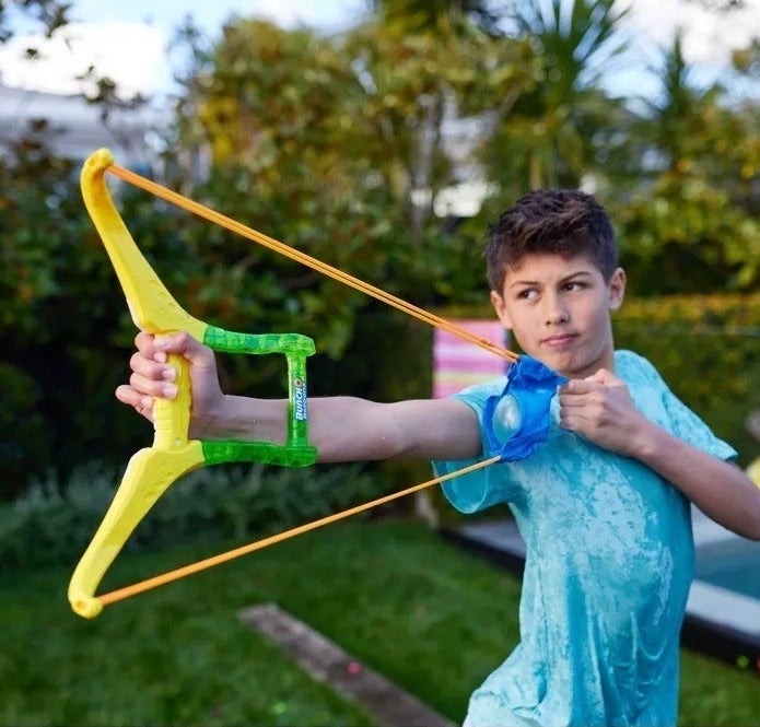 a kid playing with the sling shot