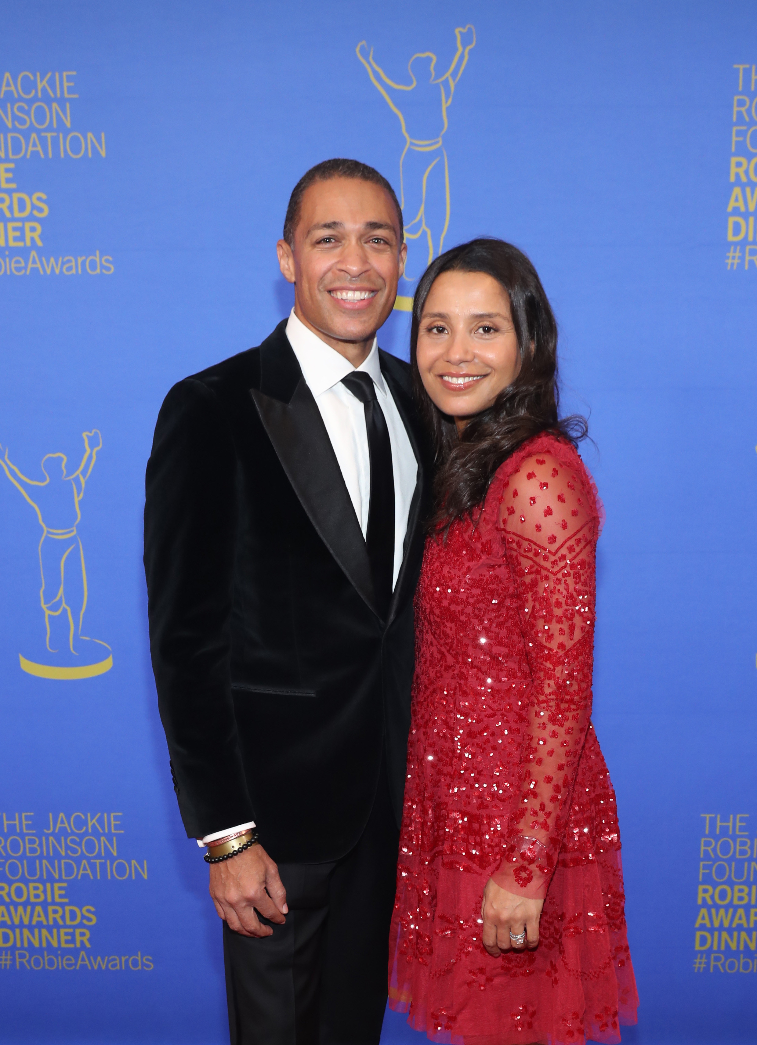 t.j. holmes and marilee holmes pose on a red carpet