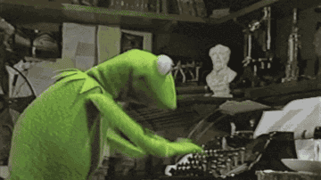 Kermit the frog furiously typing on a typewriter