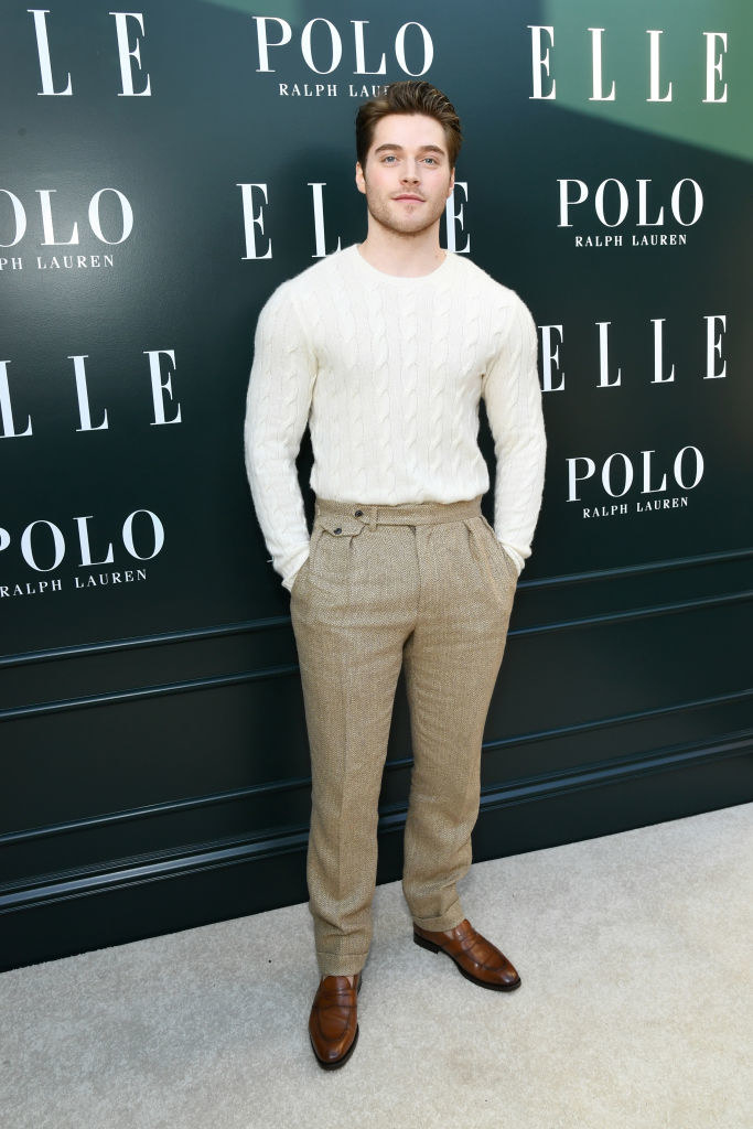in a sweater and trousers