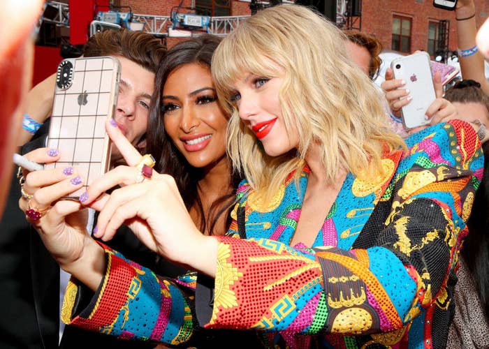 Closeup of Taylor Swift taking a selfie with fans