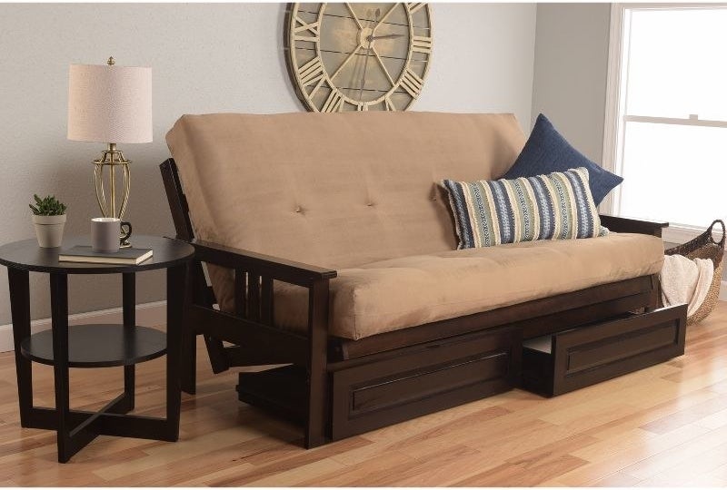 a peat suede futon with two drawers in a living room with wood floors