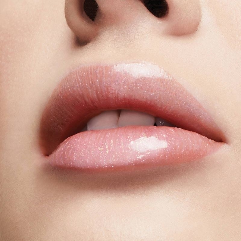 A person wearing a lip plumper gloss